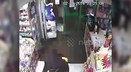 Have-a-go hero pharmacist was caught on CCTV fending off an armed robber – with a HENRY HOOVER