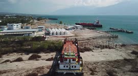 Drone footage shows large ship swept onto land by force of Palu tsunami