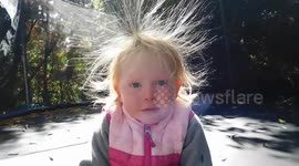 Toddler's hair becomes an adorable static mess after jumping on trampoline
