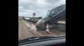 Footage shows partially upturned cars on road in aftermath of deadly Mallorca floods
