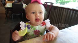 Baby eats a lemon for the first time