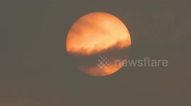 cloud cover the red sun silently , before the cyclone titli came
