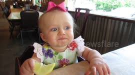 Adorable moment baby eats lemon for the first time