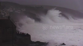 Huge swells and crashing waves in Cornwall as villagers look on