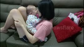 Mom does sit up kisses with baby