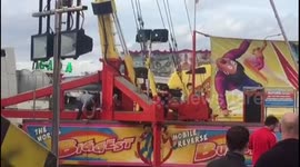 Man fixes bungee ride while people are on the ride