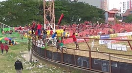 Kids Climb Stadium Fence in Makassar, Indonesia