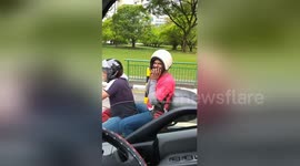 Pillion passenger wears helmet the wrong way round