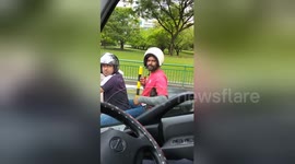 Pillion passenger wears helmet the wrong way round