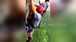 Daredevil tourists climb on a vertical cliff in central China
