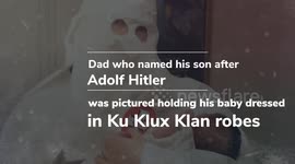 Dad pictured holding his baby dressed in Ku Klux Klan robes