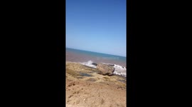 Sea running toward rocks