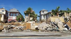 Piles of debris from flattened houses lie on side of Mexico Beach roads
