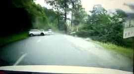 Dramatic footage shows large boulder rolling down hill and smashing car in southeast Tibet