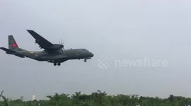 Vietnamese military planes landing overhead of motorcyclists