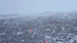 Walker in extreme winds on top of mountain