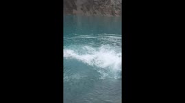 hiker jumps in freezing glacial lake in the Andes mountains