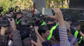 Activists trying to demolish the monument with  hatchets and ladder