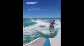 DOLPHIN and HUMAN SURFING Behind Boat