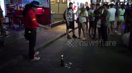 Street entertainer performs magic tricks with cigarette