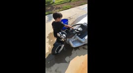 Toddler Washing his motorcycle