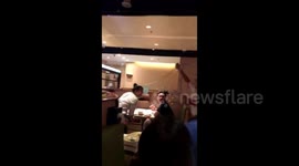 Waiter pulls single-strand noodle onto waitress’s hair