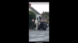 UK armed police climb on car and storm house in dramatic raid