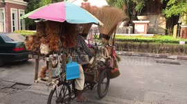 Feather duster seller riding his cart