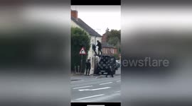 UK armed police climb on car and storm house in dramatic raid