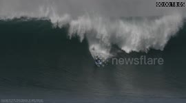 Mike Stewart, 55, paddles into Big Nazaré on a Bodyboard