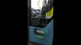 Bus driver reads newspaper behind the wheel during rush hour