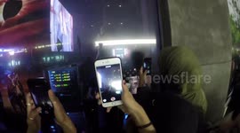 Excited London fans watch rapper Jaden Smith perform through shop window