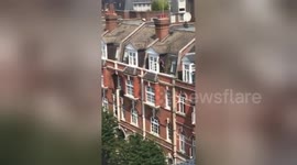 UK window cleaner seen on ledge three floors up with no safety equipment
