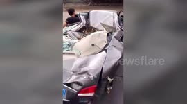 Determined motorist drives flattened car to repair shop