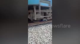 Man forced to lie down under a moving train to stop being hit