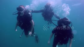 Dive Instructor controlling Students divers