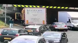 Hapless truck driver gets stuck under low bridge in UK's Rochdale