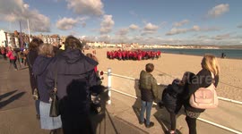 Human Giant poppy on Weymouth Beach