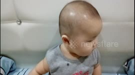 Funny footage of baby falling down on bed