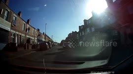 Two Idiots, one does a wheelie towards the car