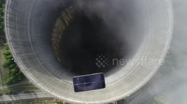 Can an iPhone XS survive a fall into an abandoned nuclear cooling tower?