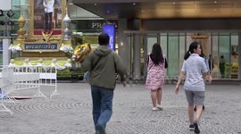 Footage shows solemn scenes outside King Power headquarters in Bangkok following owner's death