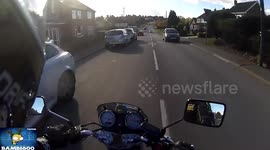 Car nearly hits motorcycle head on.