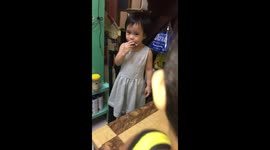 Little girl eating healthy snack.  Its garlic thing!