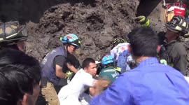 Woman pulled alive from crushed car after being buried under 14 tonnes of soil