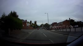 Red car turning in front of lorry dangerously close
