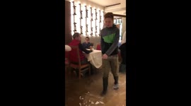 Business as usual: Venice restaurant staff wade through flood water to serve customers