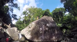 Filipino kid dives in shallow waterfall