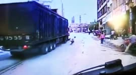 Scooter driver narrowly escapes being run over by lorry