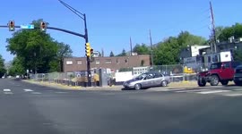 Car drives along sidewalk at intersection